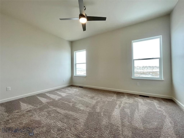 empty room featuring carpet flooring and ceiling fan