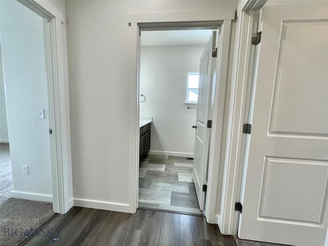 corridor featuring dark wood-type flooring