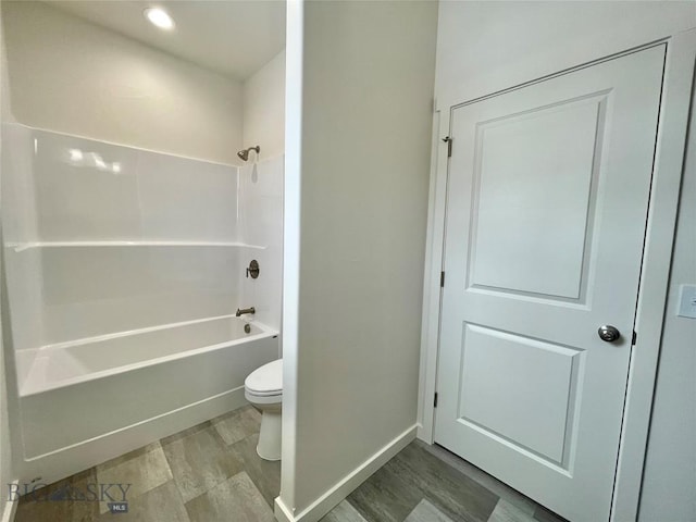 bathroom featuring shower / tub combination, toilet, and wood-type flooring