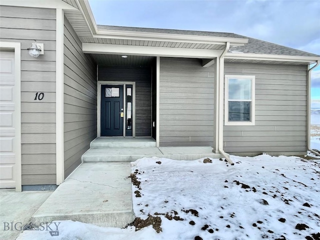 view of snow covered property entrance