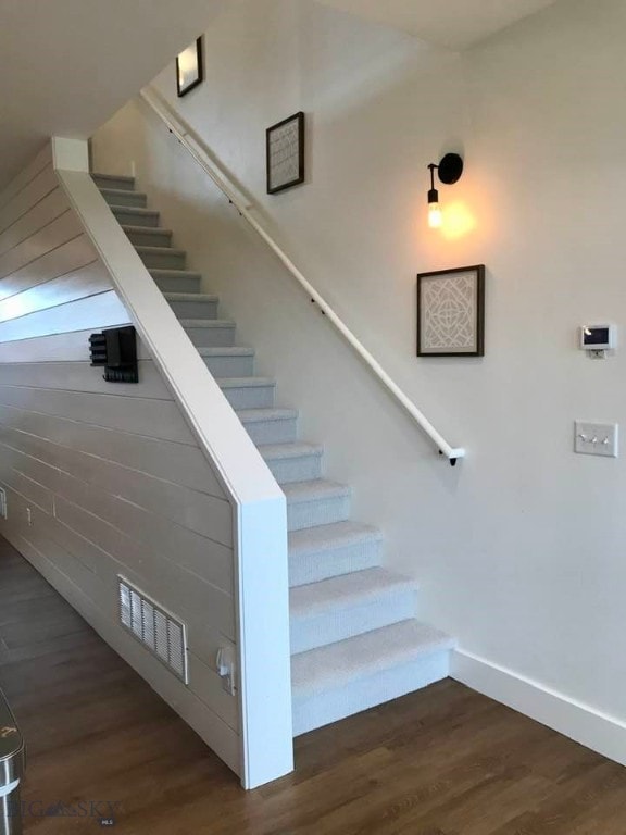 stairway featuring hardwood / wood-style floors