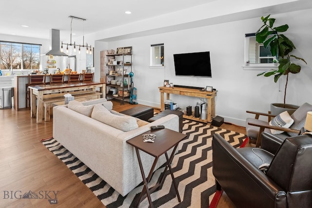 living room with a chandelier and light wood-type flooring