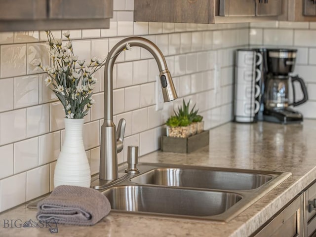 interior details featuring sink and backsplash