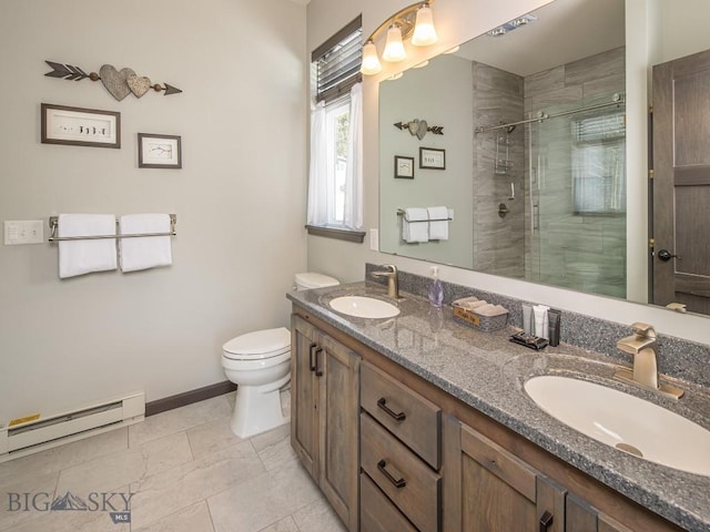 bathroom featuring vanity, toilet, a shower with shower door, and a baseboard radiator