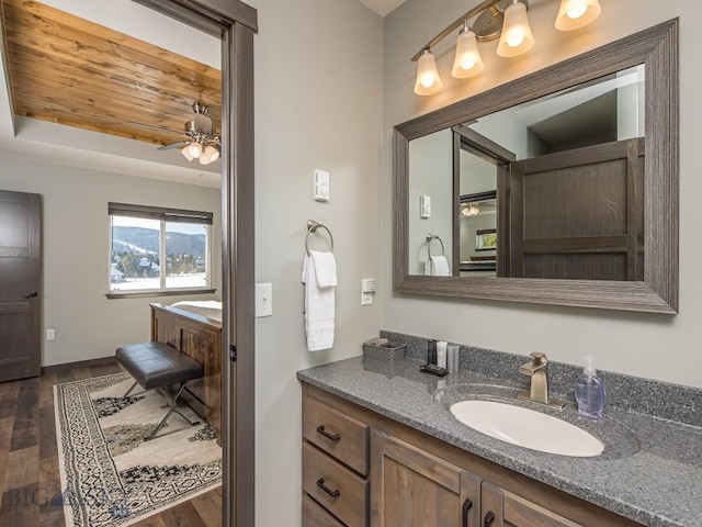 bathroom with hardwood / wood-style flooring, vanity, and ceiling fan