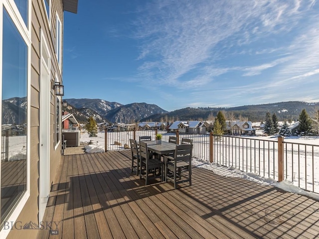 snow covered deck featuring a mountain view