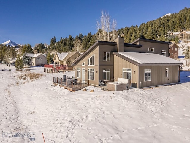 snow covered property featuring a deck