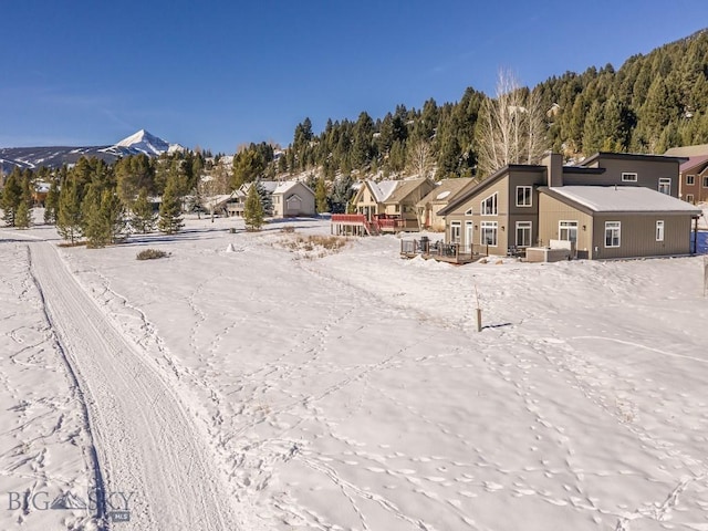 snowy aerial view featuring a mountain view