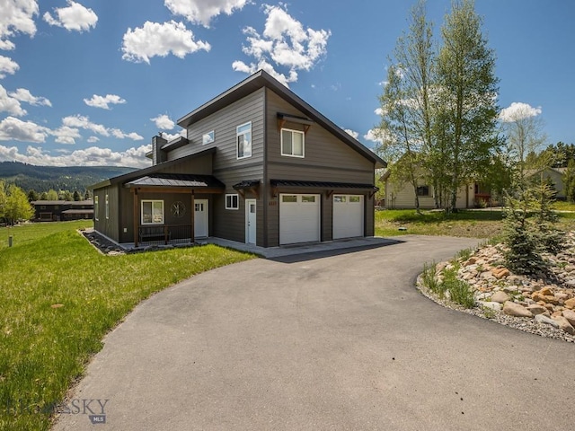 1880 Little Coyote, Big Sky, MT 59716 - view of front of property with asphalt driveway, a front lawn, and an attached garage