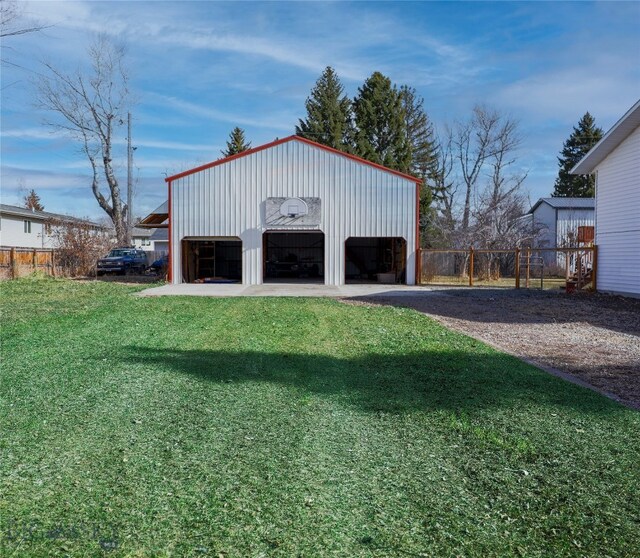 view of outdoor structure featuring a garage and a lawn