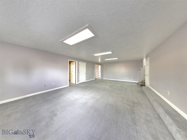 carpeted spare room featuring a textured ceiling