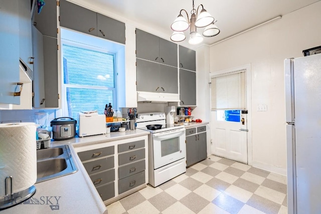 kitchen with gray cabinetry, sink, an inviting chandelier, decorative light fixtures, and white appliances