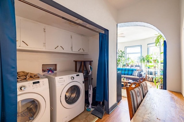 laundry area with washer and dryer and light hardwood / wood-style floors