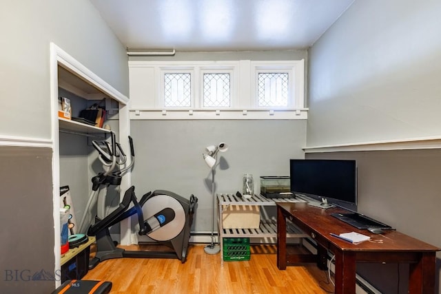 office space featuring a baseboard radiator and light hardwood / wood-style flooring