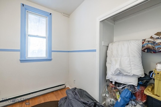 interior space featuring hardwood / wood-style floors and a baseboard heating unit