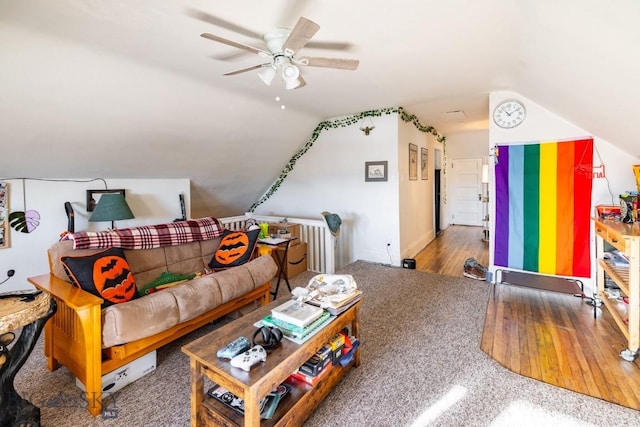 living room featuring hardwood / wood-style floors, ceiling fan, and lofted ceiling