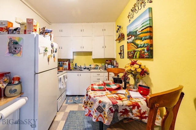 kitchen with white cabinets, white appliances, and sink