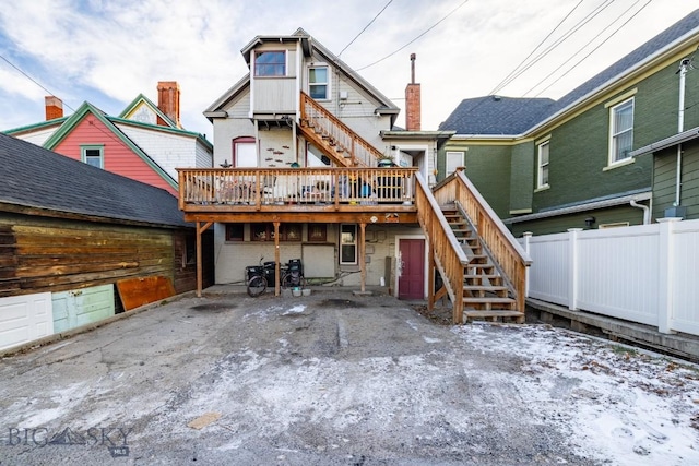 rear view of house featuring a deck