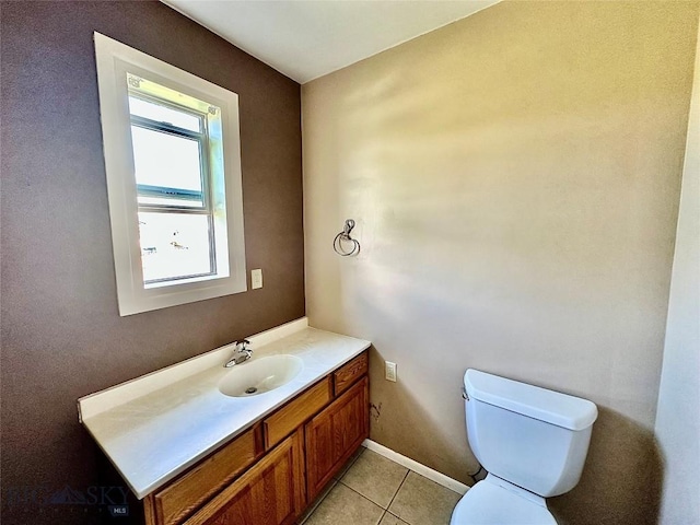 bathroom featuring tile patterned flooring, vanity, and toilet