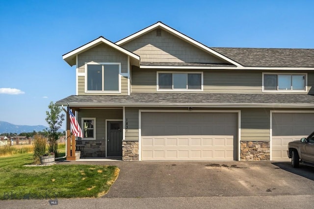 view of front facade with a mountain view and a garage