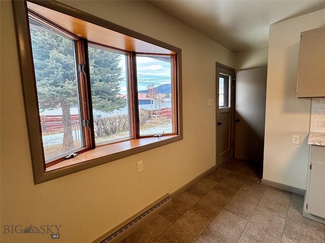 corridor featuring a baseboard radiator and a water view