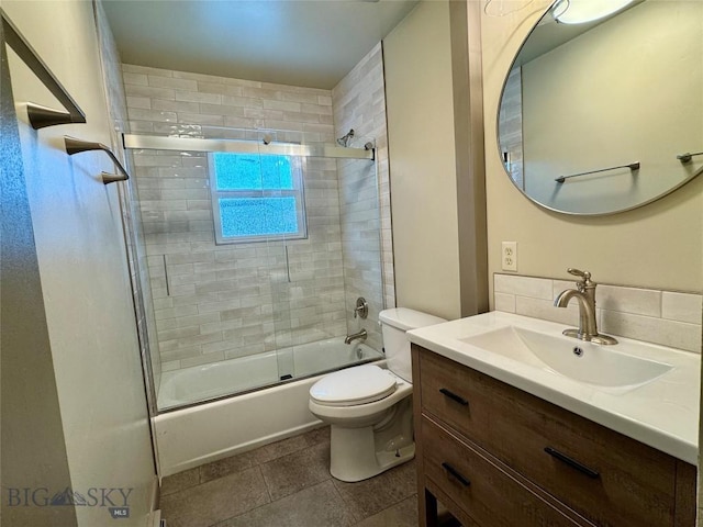 full bathroom featuring shower / bath combination with glass door, tile patterned floors, vanity, and toilet