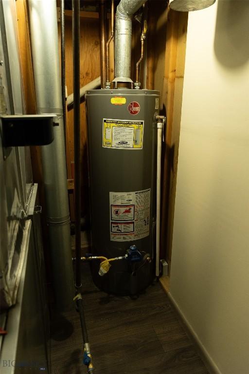 utility room featuring water heater