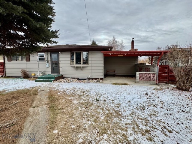 single story home featuring a carport