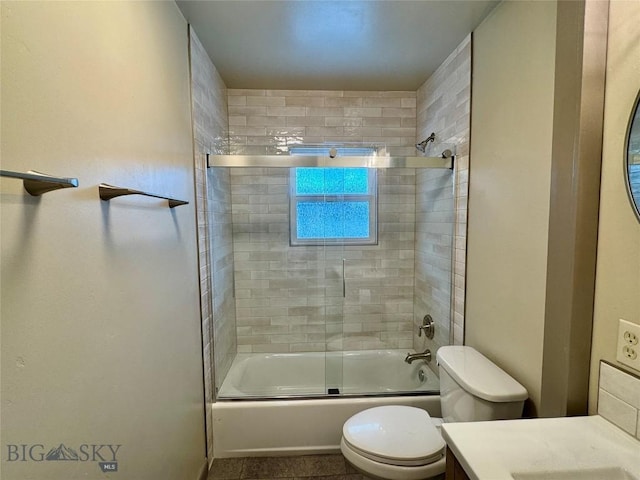 full bathroom with tile patterned floors, combined bath / shower with glass door, toilet, and vanity