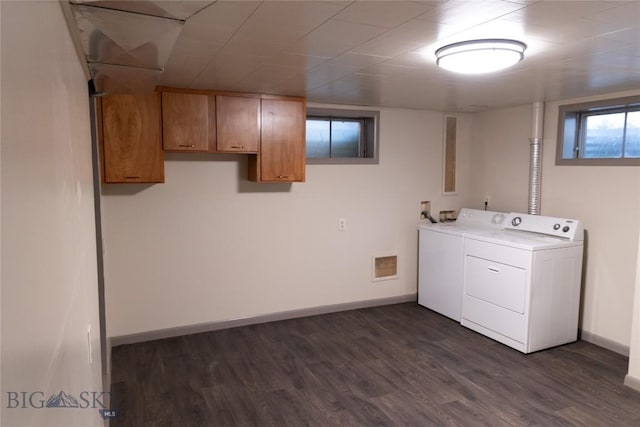 laundry area with cabinets, washer and dryer, and dark hardwood / wood-style flooring