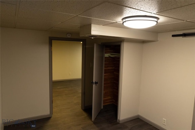 unfurnished room with a paneled ceiling and dark wood-type flooring