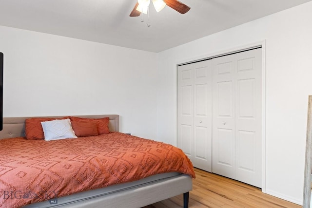 bedroom featuring ceiling fan, a closet, and light hardwood / wood-style floors