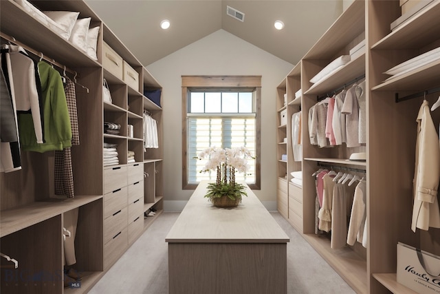 walk in closet with light colored carpet and lofted ceiling