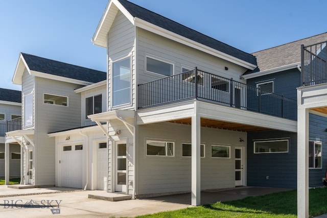 view of front facade with a garage and a balcony