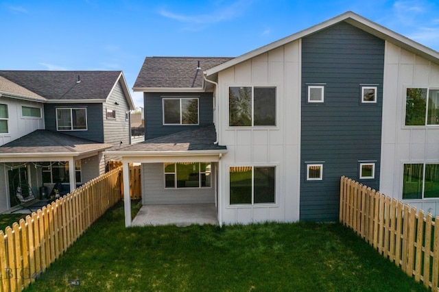 back of house featuring a yard and a patio area