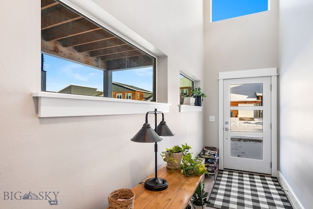 doorway to outside featuring beam ceiling