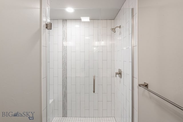 bathroom with a shower with shower door