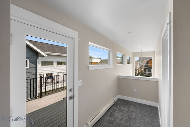 interior space with baseboard heating and dark colored carpet