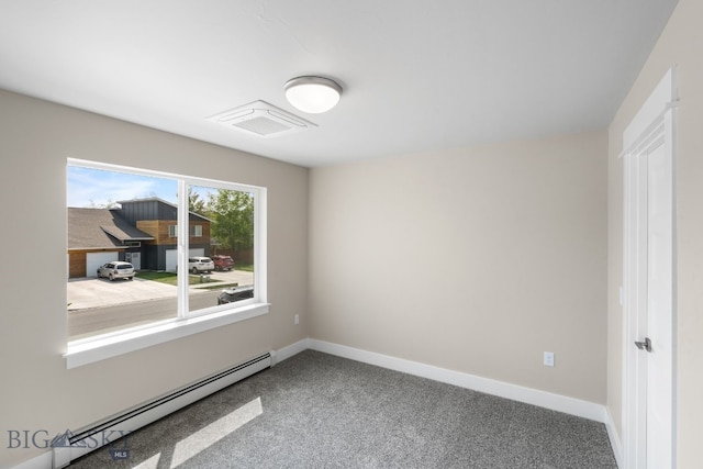 carpeted empty room with a baseboard heating unit