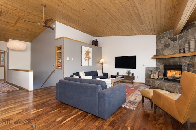 living room with vaulted ceiling with beams, a stone fireplace, wood ceiling, and hardwood / wood-style flooring