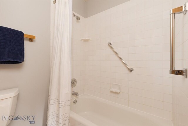 bathroom with shower / tub combo with curtain and toilet