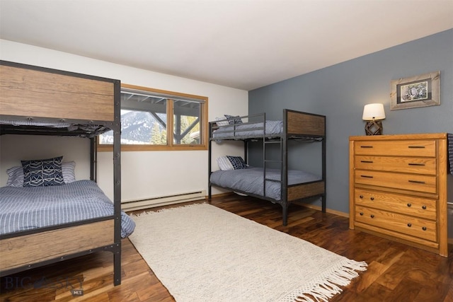 bedroom featuring dark hardwood / wood-style flooring and a baseboard heating unit