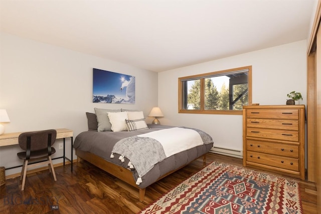 bedroom featuring dark hardwood / wood-style floors and a baseboard heating unit