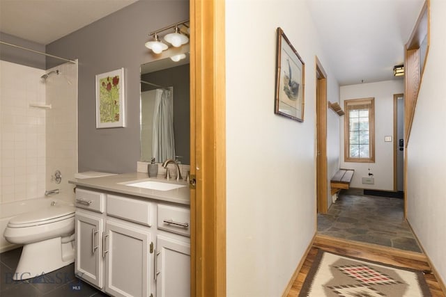 full bathroom featuring vanity, shower / bath combination with curtain, and toilet