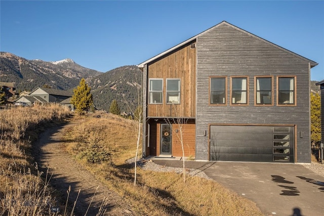 view of front of property with a mountain view and a garage