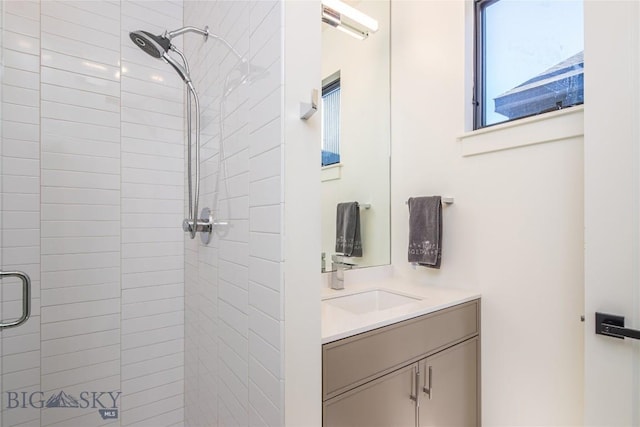 bathroom featuring vanity and a shower with door