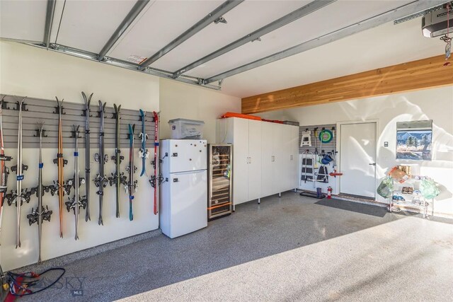 garage with a garage door opener and white refrigerator