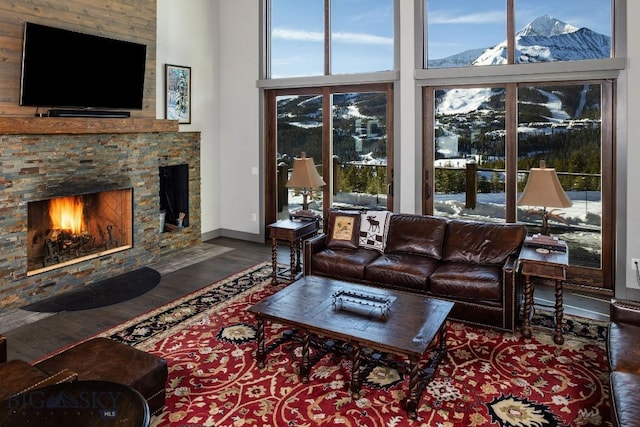 13 Middle Rider, Big Sky, MT 59716 - living room featuring wood finished floors, a fireplace, and a high ceiling