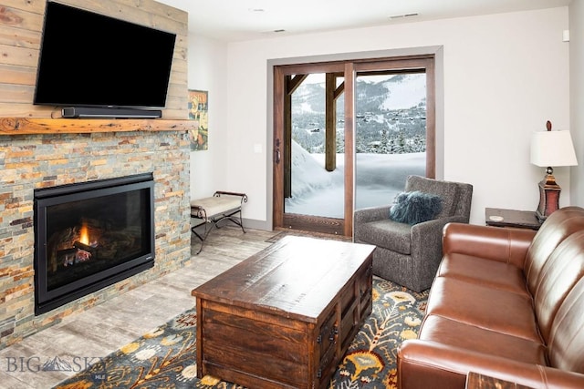 13 Middle Rider, Big Sky, MT 59716 - living room featuring wood finished floors and a stone fireplace