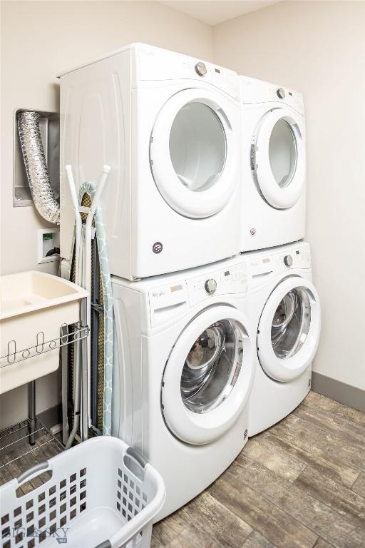 13 Middle Rider, Big Sky, MT 59716 - washroom featuring stacked washing machine and dryer and wood finished floors